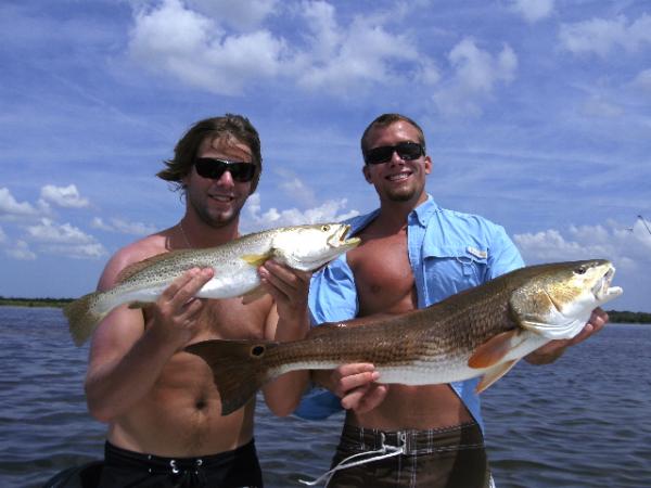 two guys with trout and redfish